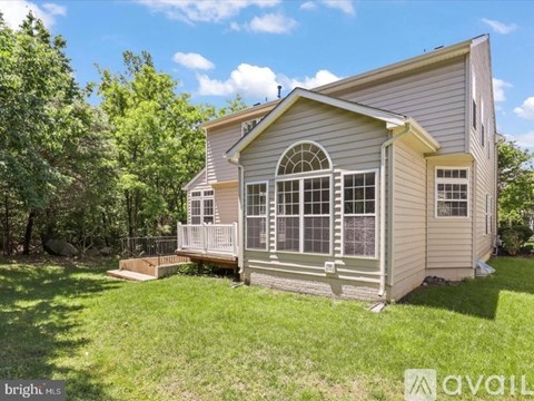 A house with a driveway and garage is available for sale.