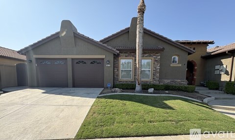 A house with a palm tree in front.