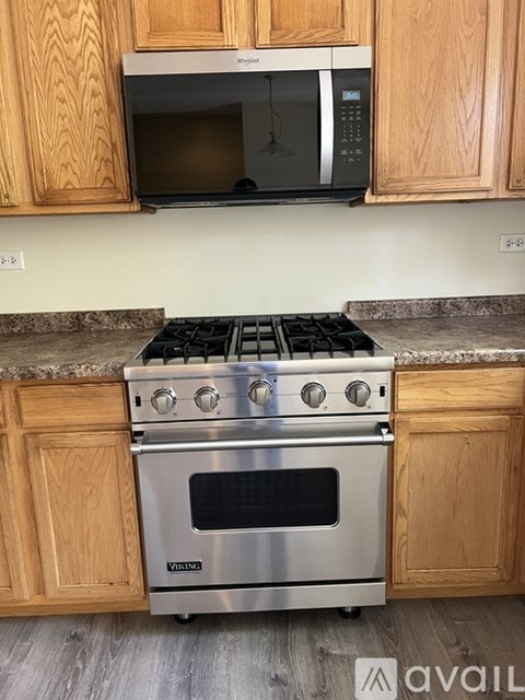 A kitchen with a stove top oven and microwave above it.