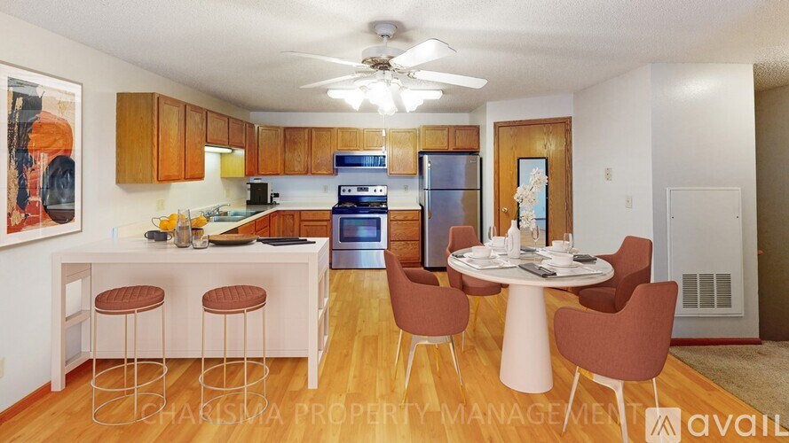A kitchen with a dining table and chairs.