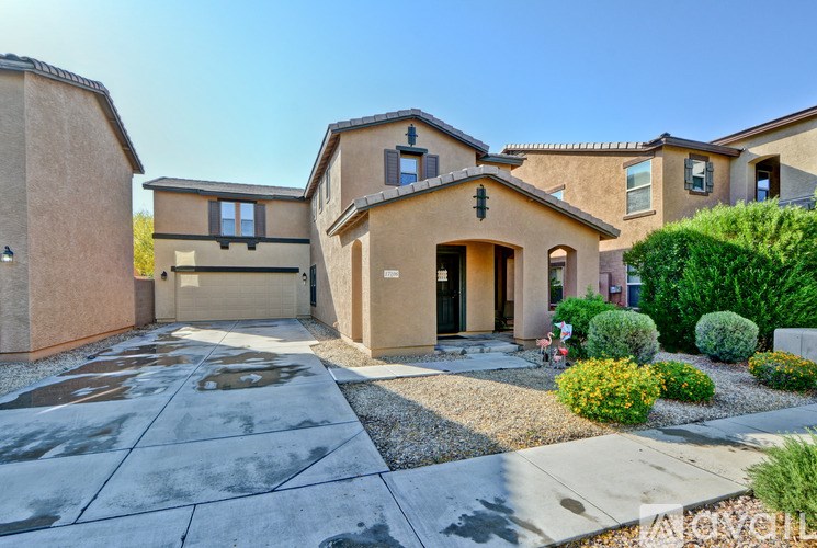 A house with a driveway and landscaping in front.