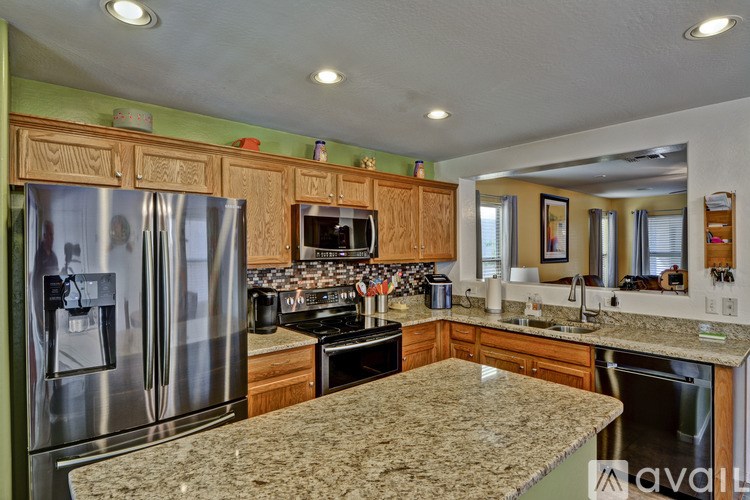 A kitchen with granite countertops and stainless steel appliances.