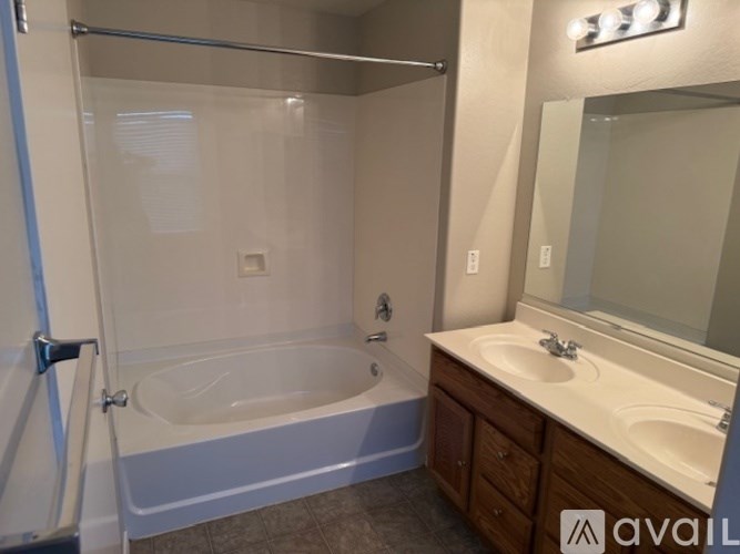 A room with wooden flooring and a ceiling fan.