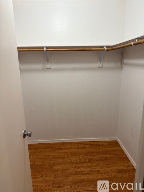 A room with a wooden floor and a white wall.