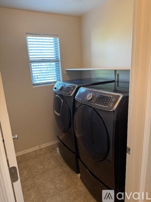 Two front loading washing machines in a laundry room.