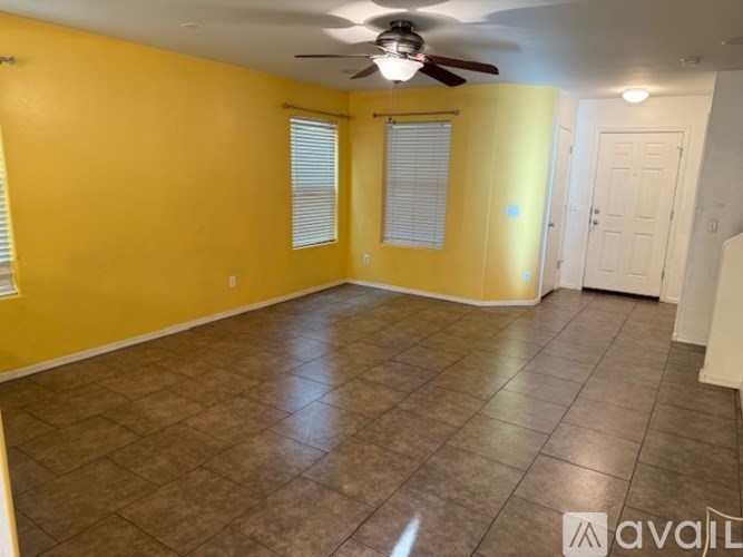 A kitchen with a granite countertop and wooden cabinets.