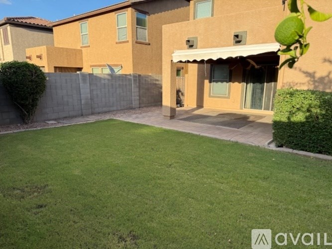 A house with a large backyard and a fence.