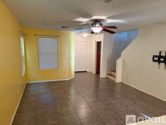 A kitchen with granite countertops and a dining area with chairs.