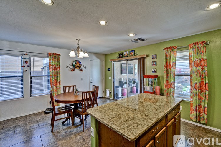 A kitchen with a table and chairs in the middle of the room.