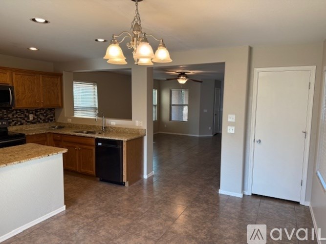 A house with a flag on the porch and a garden in front.