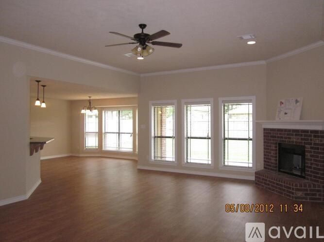 A living room with a fireplace and a fan.