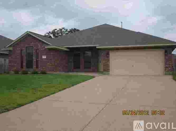 A house with a red brick exterior and a grey roof is available for sale.