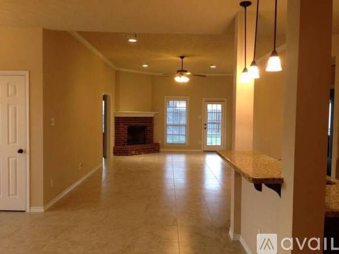 A kitchen with wooden cabinets and a granite countertop.