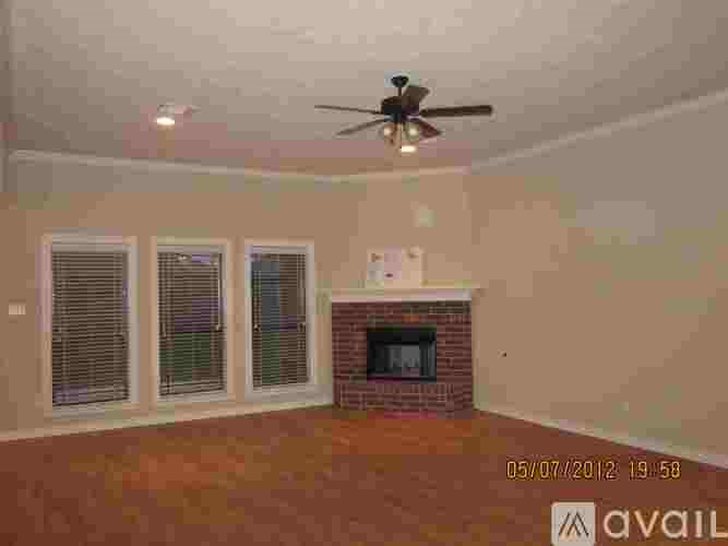 A room with a fireplace and a ceiling fan.