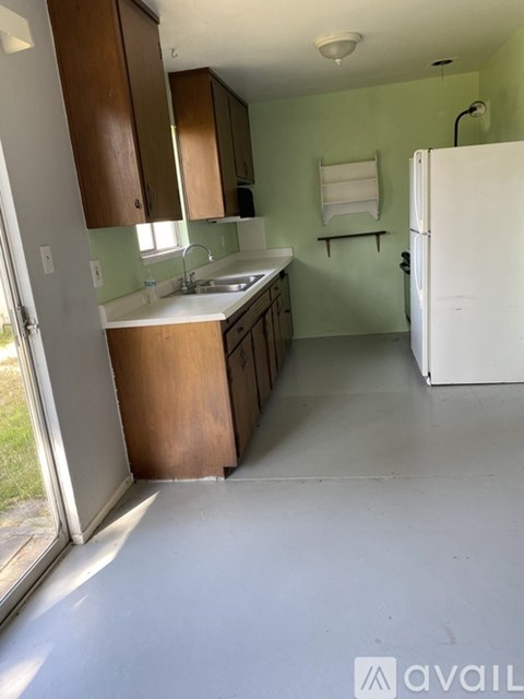 A kitchen with green walls and white appliances.