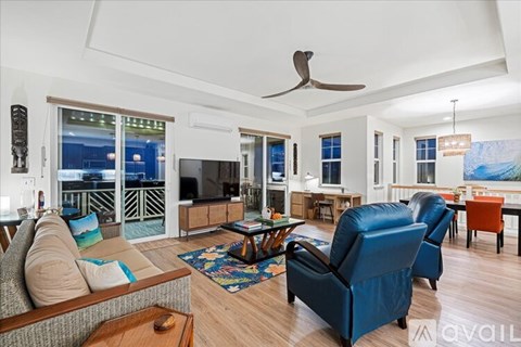 A living room with a blue couch and a wooden coffee table.