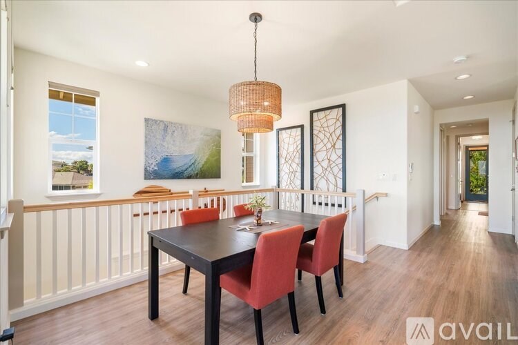 A dining room with a table and chairs.