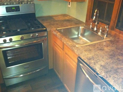 A kitchen with a stove and a sink.
