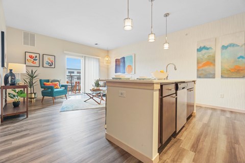 A kitchen with a white countertop and a white dishwasher.