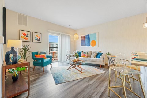 A living room with a blue chair and a white couch.