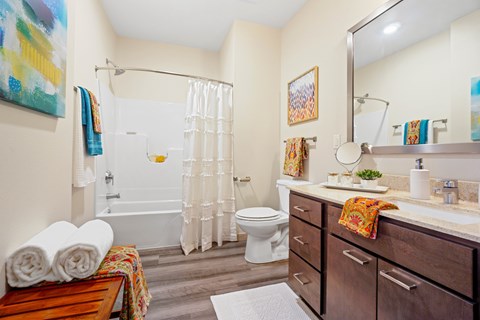 A bathroom with a white toilet, a white sink, and a white shower curtain.