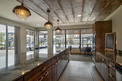 A modern kitchen with wooden cabinets and a large island.