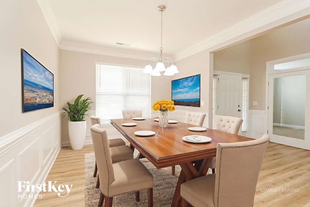 A dining room with a wooden table and chairs.