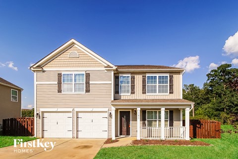 A two-story house with a garage is for sale.