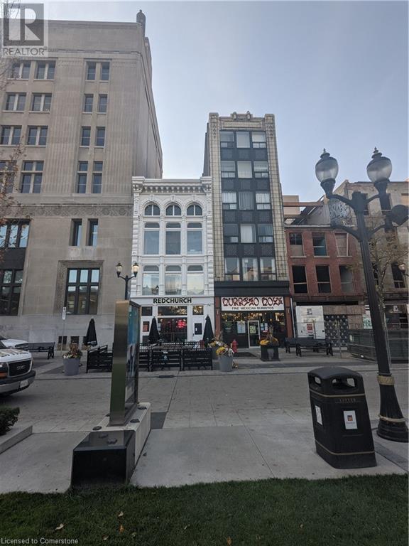 A city square with a street light and a trash can.