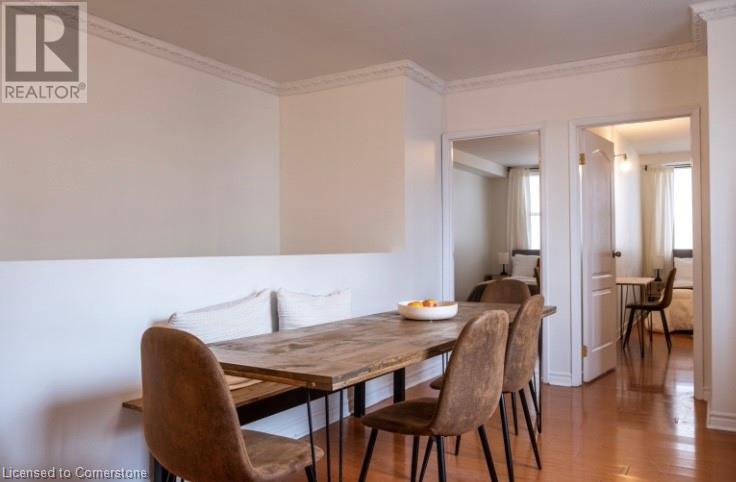 A dining room with a wooden table and chairs.