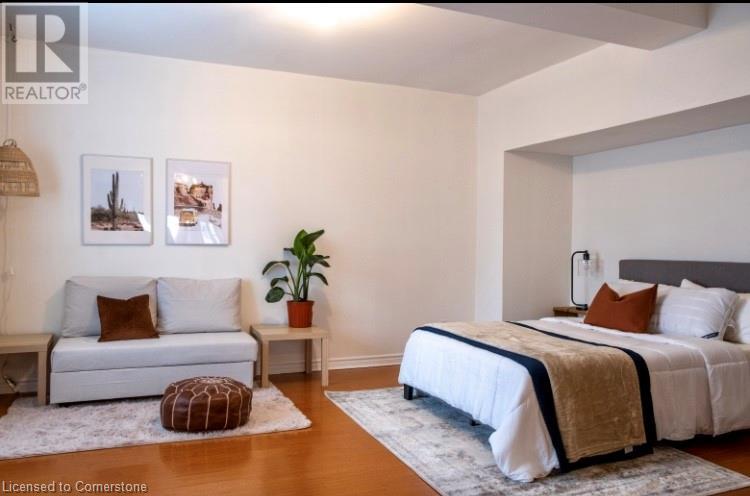 A bedroom with a white bed and a white couch.