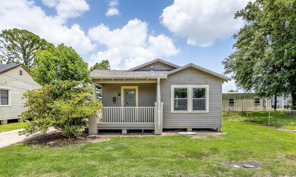A house with a grey roof and a porch.