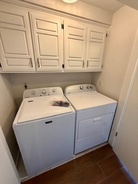 A small laundry room with a washer and dryer.