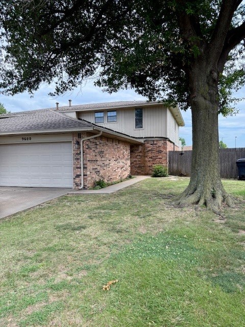 A house with a garage and a tree in front.