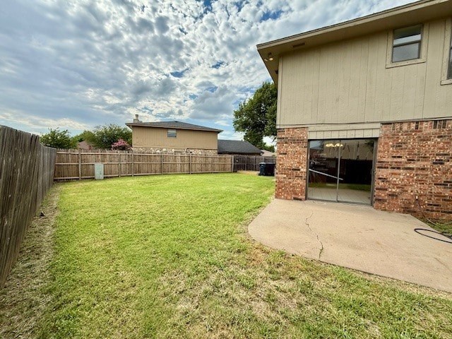A backyard with a fence and a house.