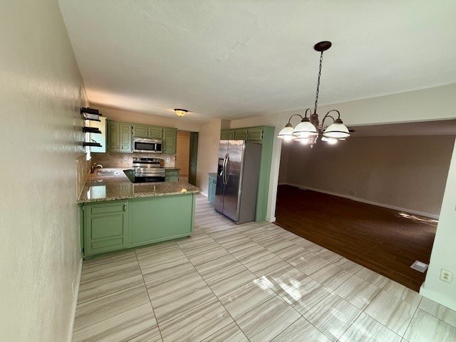 A kitchen with green cabinets and a refrigerator.