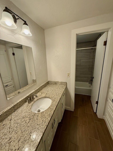 A bathroom with a sink and mirror.