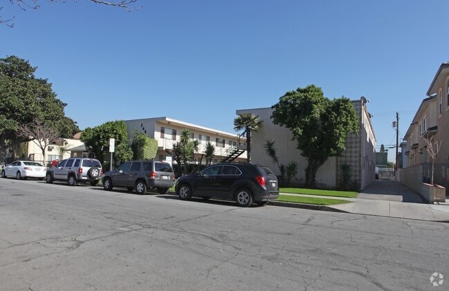Cars parked on a street in front of a building.
