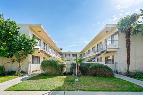 A sunny day at a residential complex with a clear blue sky.