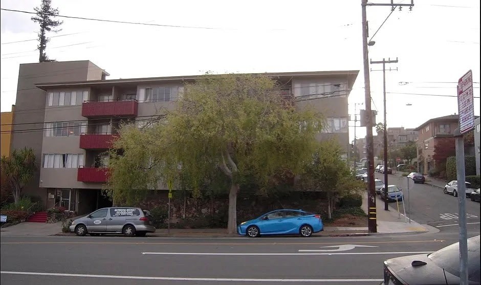 A blue car is parked on the side of the street.