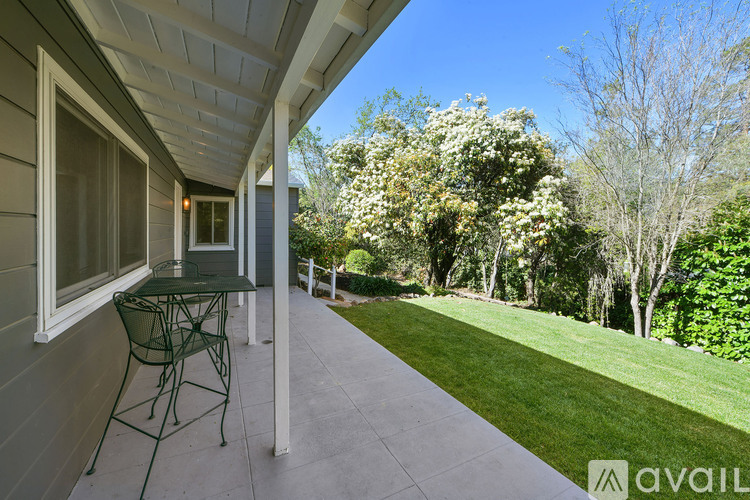 A patio with a table and chairs is available for rent.