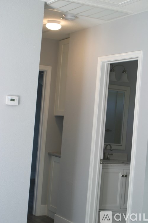 A white door is open to a bathroom.