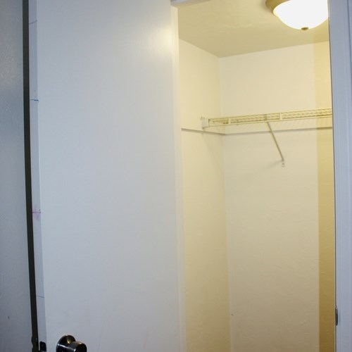 A white door with a black handle is open.