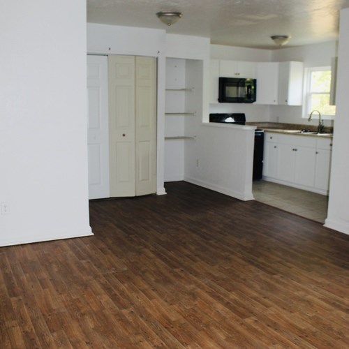 A kitchen with white cabinets and a black dishwasher.