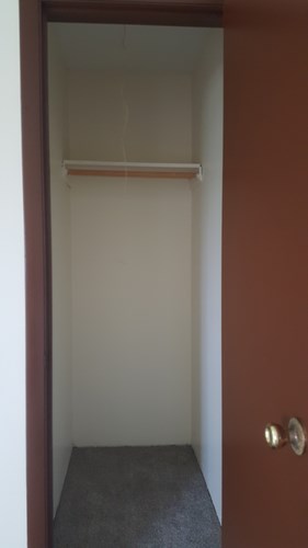A brown door with a white door frame and a silver handle.