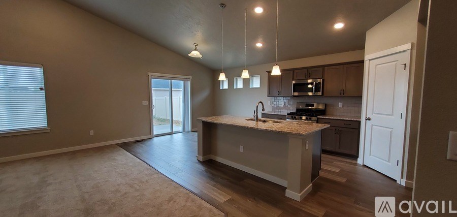 A kitchen with a granite countertop and a white door.