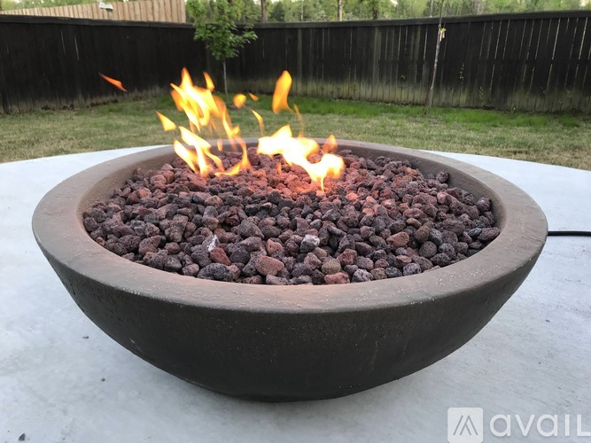 A fire pit with a blaze of fire in it.