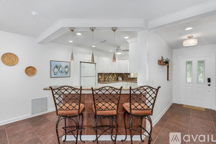A dining room with a table set for four.