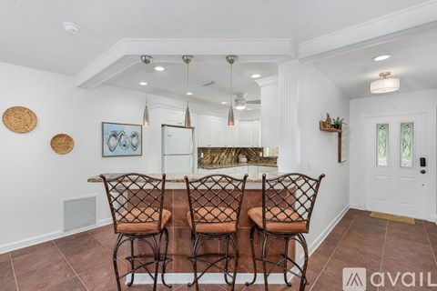 A dining room with a table set for four.