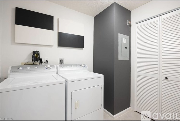 A bathroom with two sinks and a cabinet.